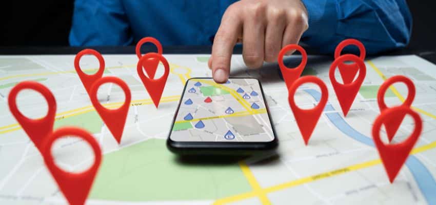 Finger tapping on a local tree service listing on a mobile phone.