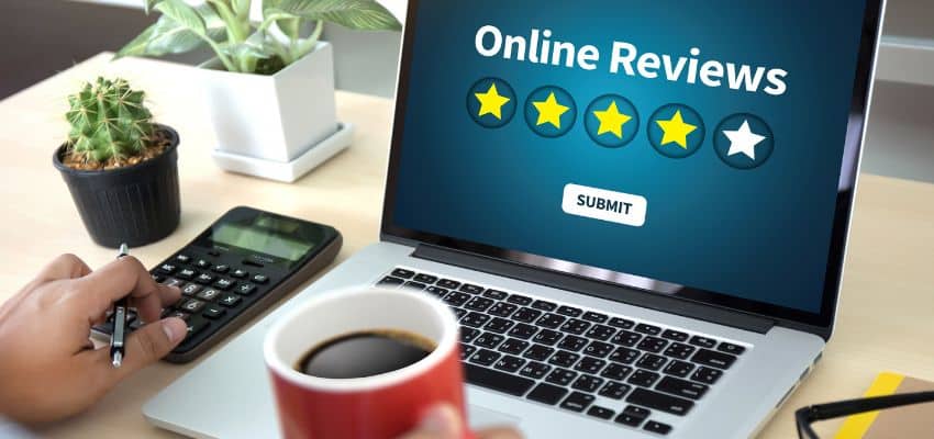 Laptop showing online reviews and star rating.